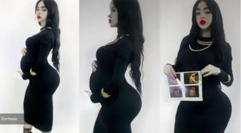 ;ujer luce su embrazo luciendo un vestido negro 